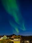 Aurora over the town. Town Tasiilaq (former Ammassalik), the biggest town in Greenland., autumn Art Print